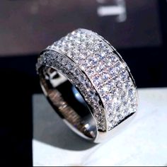 a diamond ring sitting on top of a table