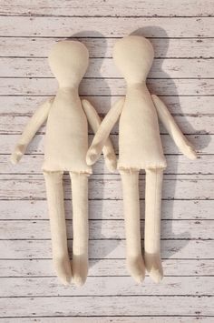 two stuffed dolls standing next to each other