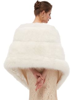 a woman wearing a white fur cape