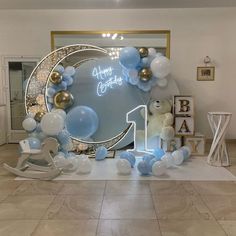 a birthday party with balloons and teddy bears on the floor in front of a mirror