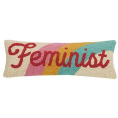 a pillow with the word feminist on it