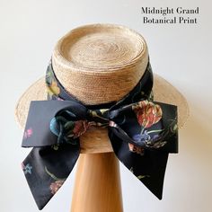 Our signature Middy Bow hat band is a removable hatband and bow combination that fits all of our ladies hat styles. The bow hatband is easily removable via a hidden closure and can be switched out for a different band in a matter of seconds, allowing you to mix and match hat shapes and bands to curate your own signature sun hat collection. Hidden Velcro dots hold the band securely in place on the hat. This listing is for one Middy Bow Hatband only. Hats shown below are the Meadow Hat, Tailored M Elegant Adjustable Hat With Bow, Adjustable Bow Boater Hat For Kentucky Derby, Adjustable Boater Hat With Bow For Kentucky Derby, Chic Adjustable Brimmed Top Hat, Elegant Hat Bands One Size Fits Most, Brimmed Boater Hat With Bow For Kentucky Derby, Adjustable Bow Hat For Kentucky Derby, Adjustable Hats With Bow For Kentucky Derby, Short Brim Sun Hat With Ribbon For Garden Party