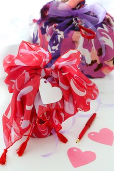 two valentine's day gift bags with hearts on them