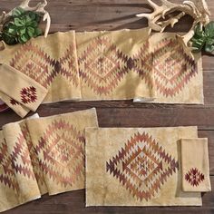 three rugs and two place mats on a wooden table