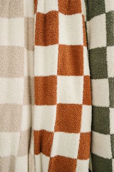 three different colored towels hanging on a rack together in the same color and pattern as seen from above