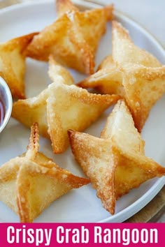 some food is on a white plate with dipping sauce