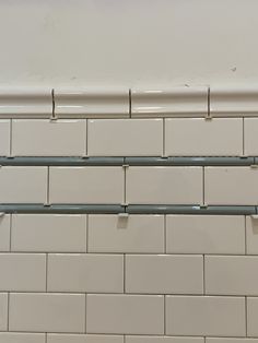 white subway tile with metal bars on each side