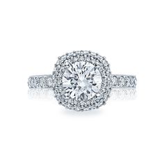 a diamond engagement ring with two rows of pave diamonds on the band and an oval halo