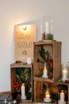 three wooden crates with lit candles in them and a sign that says happy gold outside