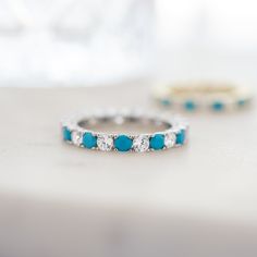 This gorgeous two-stone eternity ring can add a pop of color to any look with the stunning Turquoise stones, while still having the beautiful shine from the CZ stones! Made of 925 Sterling Silver THICK plating of 14k Gold or Rhodium Available in Sizes 4-12 Made of highest quality cubic zirconia and lab-created turquoise 3mm Stones VERY HIGH QUALITY Nickel-free & Hypoallergenic - will NOT turn fingers green! Ring Sizer Tool 🎁 Comes in a gift-box, ready for gift giving!✈️ Ships same day for fast Turquoise Jewelry With Gemstone Accents For Promise Ring, Turquoise Gemstone Jewelry For Promise Ring, Turquoise Ring With Accent Stones For Promise, Turquoise Birthstone Ring With Accent Stones, Round Turquoise Ring With Gemstone Accents, Turquoise Cubic Zirconia Jewelry For Anniversary, Turquoise Birthstone Ring With Accent Stones For Anniversary, Anniversary Turquoise Cubic Zirconia Jewelry, Turquoise Ring With Prong Setting