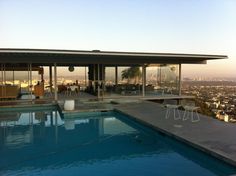 an outdoor swimming pool in front of a cityscape