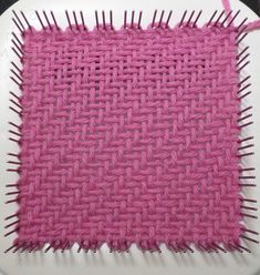 a white plate topped with pink woven material