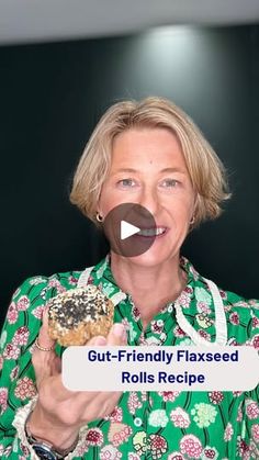 a woman holding a donut in front of her face with the caption gut - friendly flaxed rolls recipe