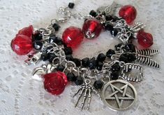 "This beautiful bracelet has red faceted beads, red glass rose beads, black czech glass beads, silver foil beads, sterling silver plated bead caps, pewter silver pentacle and pewter silver charms . 7\" long can be adjusted to 9\". Lobster clasp." Gothic Halloween Bracelets Gift, Gothic Halloween Bracelets As A Gift, Gothic Bracelets For Halloween Gift, Handmade Gothic Bracelets For Party, Gothic Red Jewelry With Lobster Clasp, Red Gothic Jewelry With Lobster Clasp, Red Beaded Bracelets For Halloween Gift, Dragons Breath Fire Opal, Wicca Jewelry