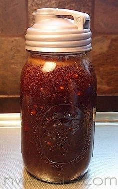 a jar filled with liquid sitting on top of a table