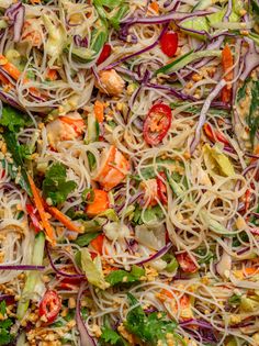 a salad with noodles, carrots and other vegetables