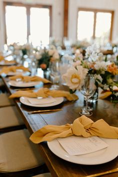 the table is set with place settings and napkins for guests to sit down at