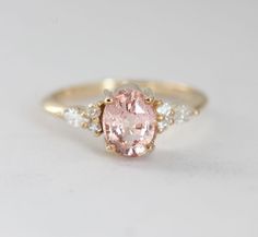 an oval pink and white diamond ring