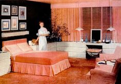 a woman standing in the middle of a bedroom next to a bed and dressers