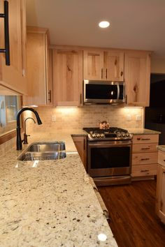 a kitchen with wooden cabinets and granite counter tops