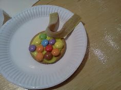 a paper plate that has some kind of candy in it on top of a table