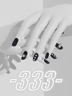 a white mannequin with black and white nail designs on it's hands