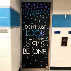 a door with the words don't just look at the stars be one on it