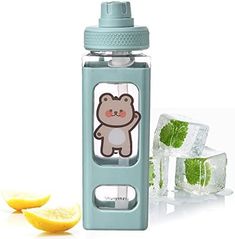 a water bottle with an animal sticker on it next to lemons and ice cubes