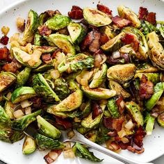 brussel sprouts with bacon and onions on a white platter, ready to be eaten