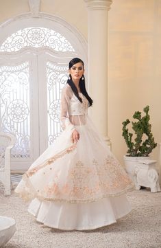 FREE SHIPPING NATIONWIDE Beautify your special occasion with this stunning off-white dress. featuring an organza body with 12 panels that boast intricate adda work on both the front and back. The dupatta is organza with embroidered borders and the lehenga is made of fused raw silk. Let your beauty shine through with this luxurious ensemble. COLOUR: Off White FABRIC: Organza, Raw silk SHIRT: Organza Body with Adda Work 12 Panels Maxi with Adda Work On Both Front And Back DUPATTA: Organza With Embroidered Borders 3yards LEHANGA: Fused Raw Silk 5yards Luxury White Dupatta For Marriage, Chiffon Collection, Off White Dresses, Eid Collection, Designer Suits, Pakistani Fashion, Formal Wedding, Clothes Collection, Raw Silk