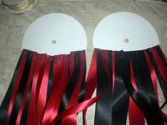 two pairs of sandals with red and black ribbons on them