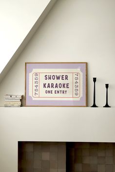 there is a sign above the fireplace in this living room that says, shower karaoke one entry