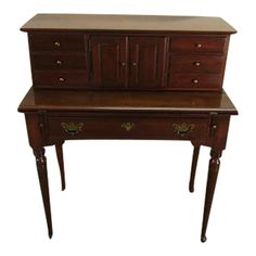 an old wooden desk with drawers on the top and bottom drawer, in dark wood