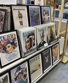 there are many posters on display in the store, including women's magazine covers