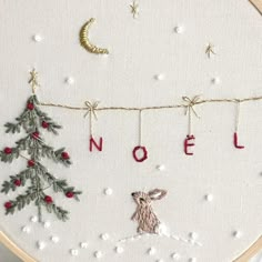 a cross stitch christmas scene with the word noel on it