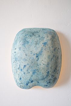 a blue stone hanging on the wall