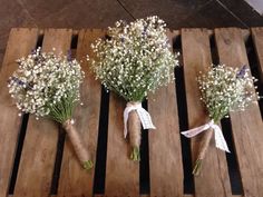 three bouquets of baby's breath tied to wooden pallets