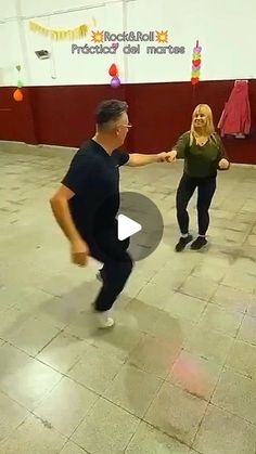 a man and woman dancing on the dance floor