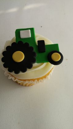 a cupcake with a green tractor on it