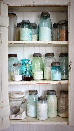 some jars are sitting on shelves in a room