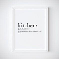 a white framed poster with the words kitchen in black ink on it's side