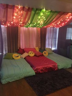 a bed with two pillows on top of it in front of a curtained window