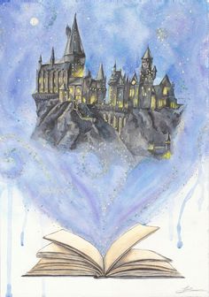 an open book sitting on top of a table next to a drawing of hogwart's castle