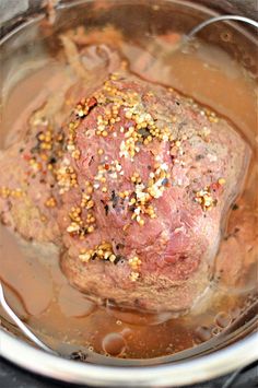 a meatloaf in a pot with spices and seasoning on top, ready to be cooked