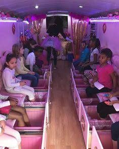 a group of people sitting in pink benches