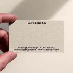 a person holding up a business card in their hand with the word tape studios on it