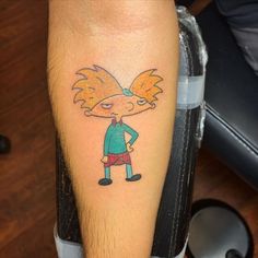 a person with a cartoon tattoo on their leg