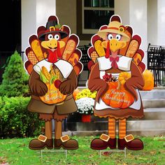 two thanksgiving turkeys standing in front of a house