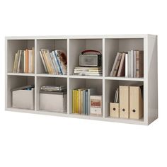 a white book shelf with many books on it and some folders next to it