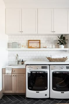 an image of a kitchen setting with washer and dryer in the foreground